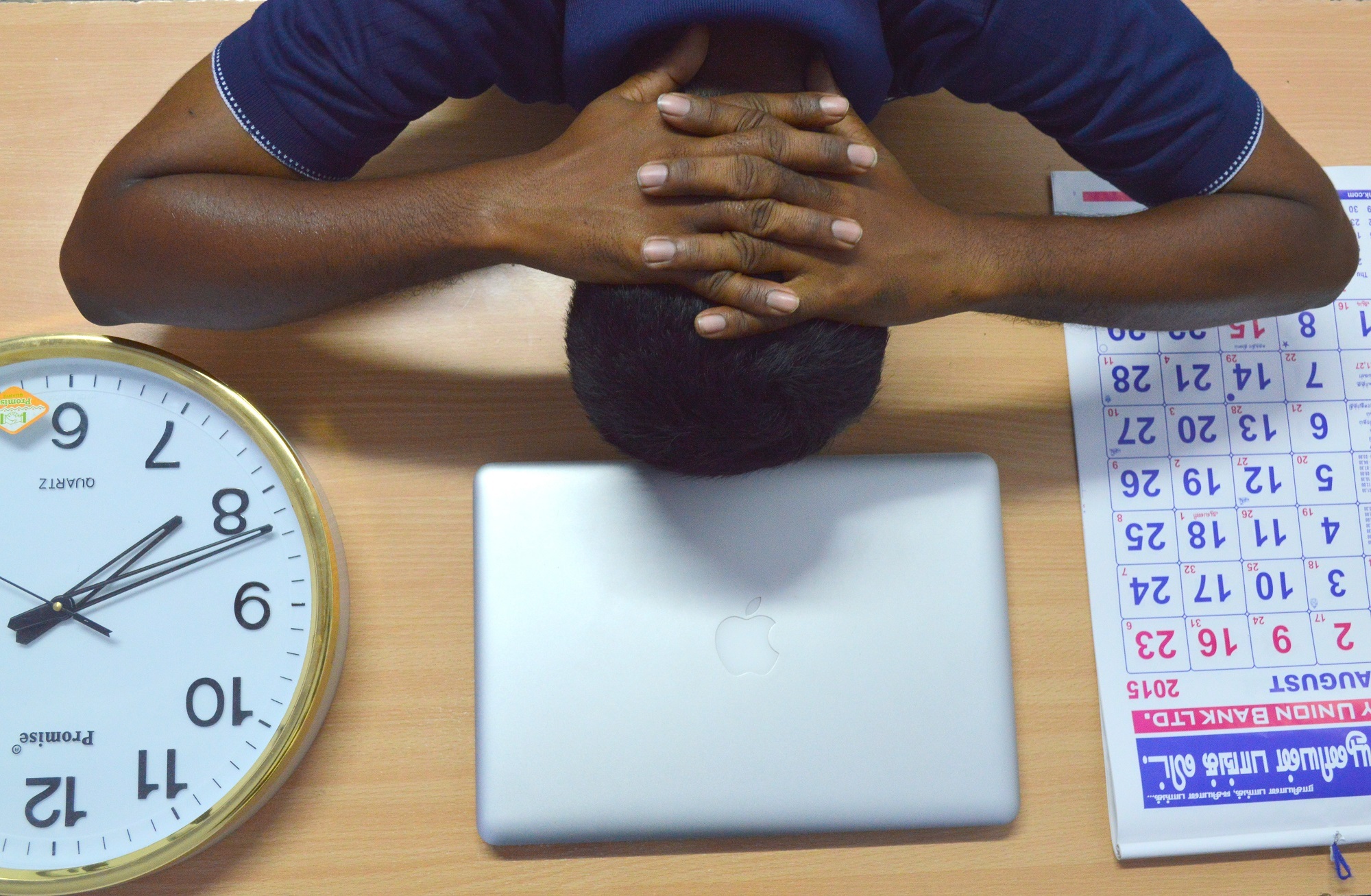 a clock, calendar, and a stressed man